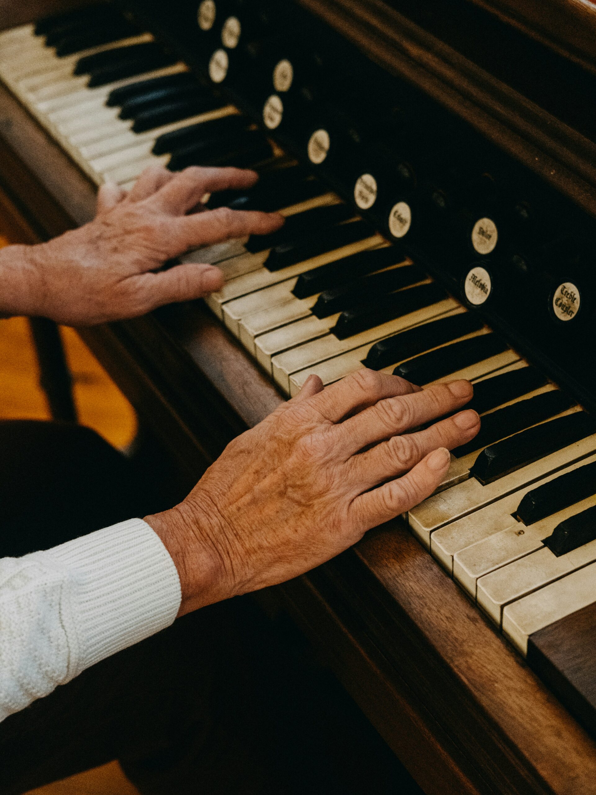 Elderly person plays piano in the Short-term rehab center.